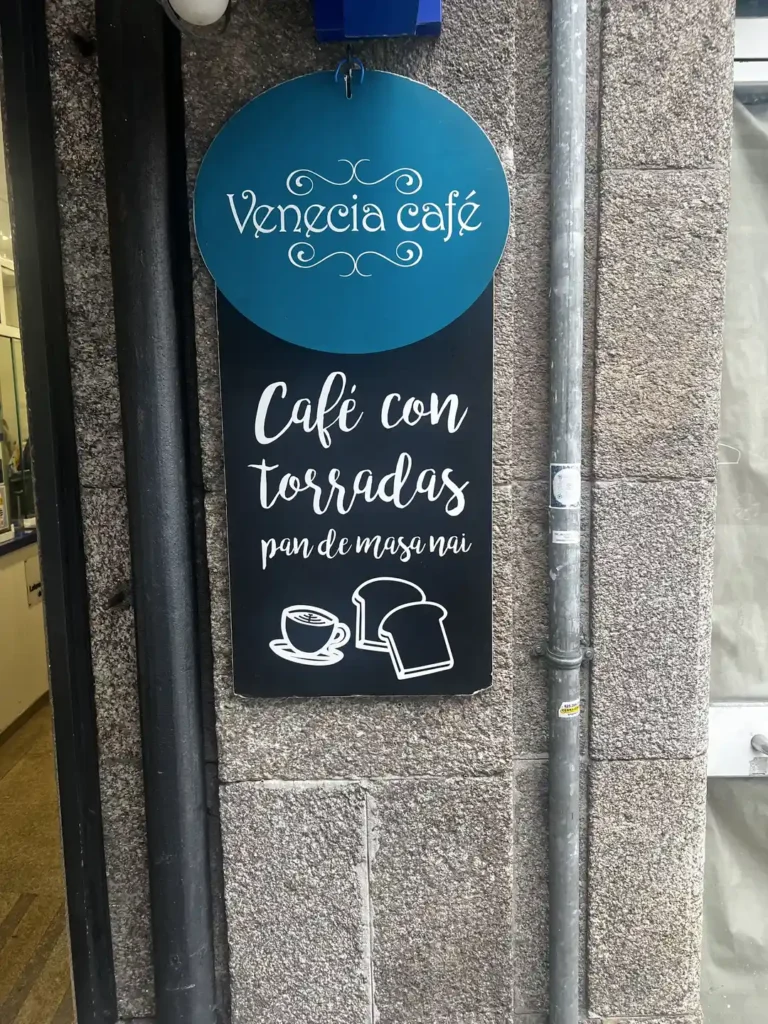 Cartel del Venecia Café en Santiago de Compostela anunciando café con torradas de pan de masa madre